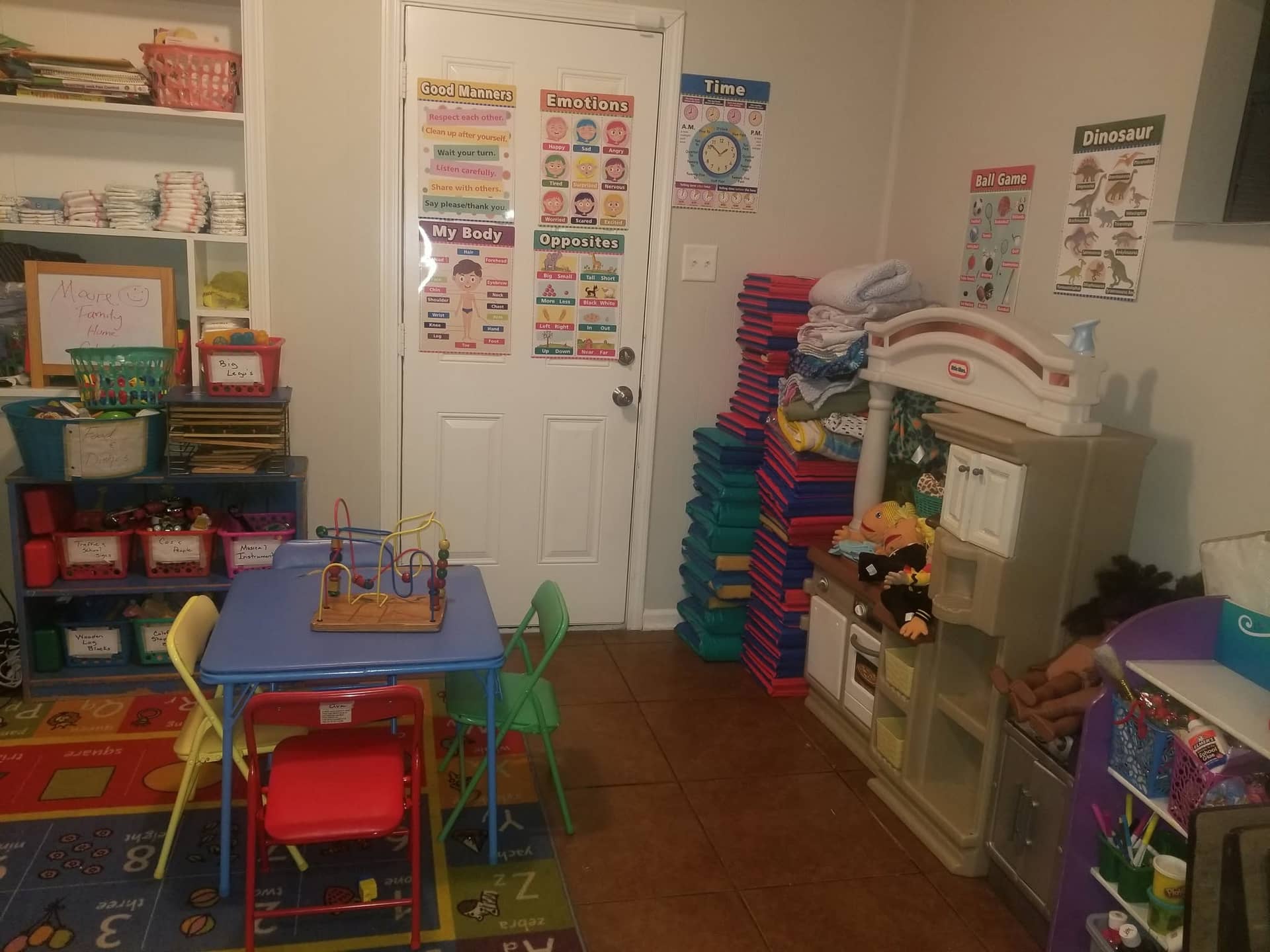 Moore Family Home ChildCare classroom with toys, tables, and learning posters