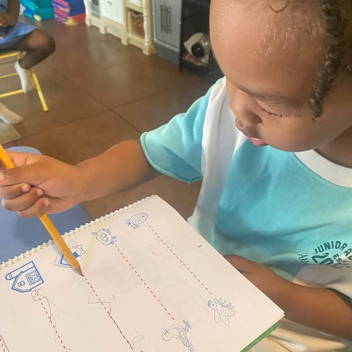 A child practicing writing at the table