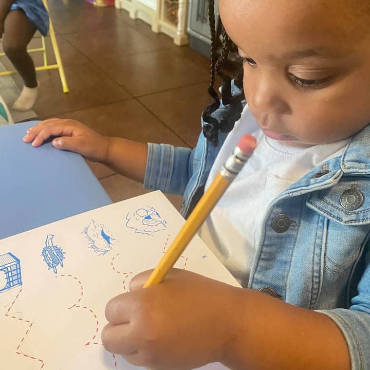 A child drawing with a pencil